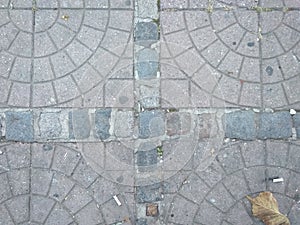 ÃÂ Tiled square paviment ground in the street.